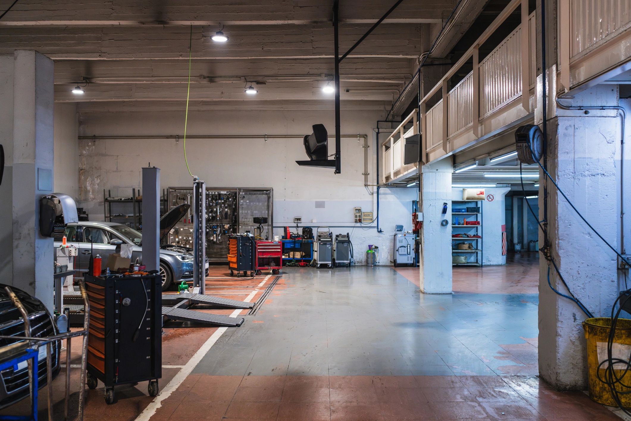 Clean, modern auto repair shop service bay with lifts