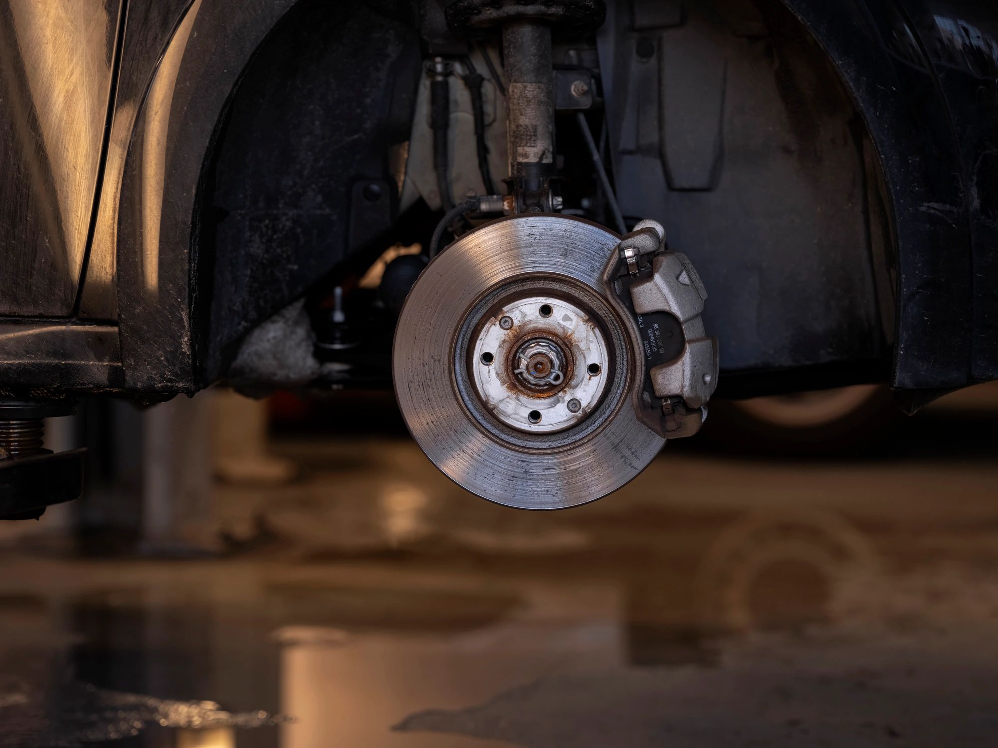 Close-up of brake rotor and caliper during service